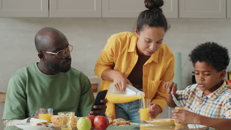 Little-African-American-Boy-Talking-with-Parents-on-Home-Breakfast